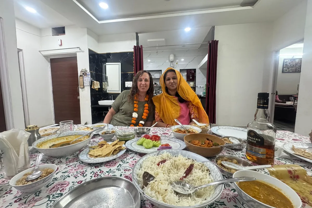 Guests enjoying a shared Indian meal indoors